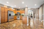 Kitchen with stainless steel appliances, breakfast bar for 2